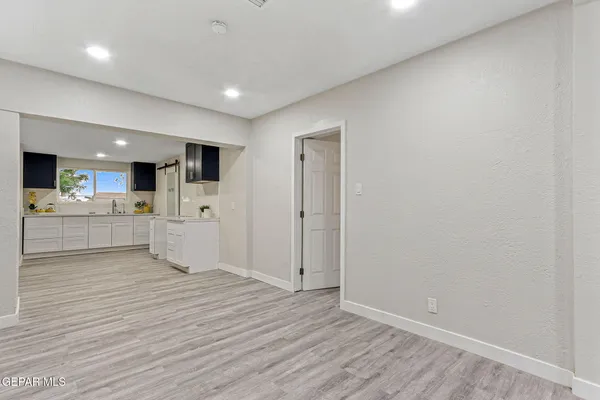 a kitchen with refrigerator and cabinets