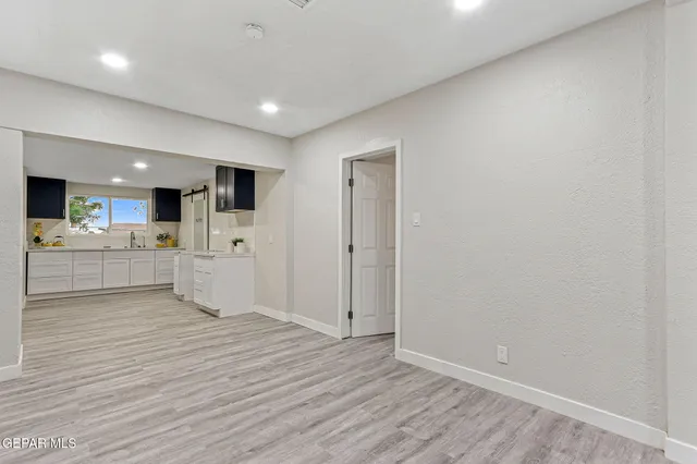 a kitchen with refrigerator and cabinets