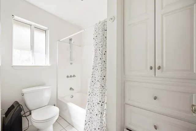 a white toilet sitting next to a bathroom sink