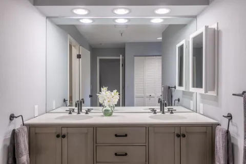 a bathroom with a double vanity sink and a mirror