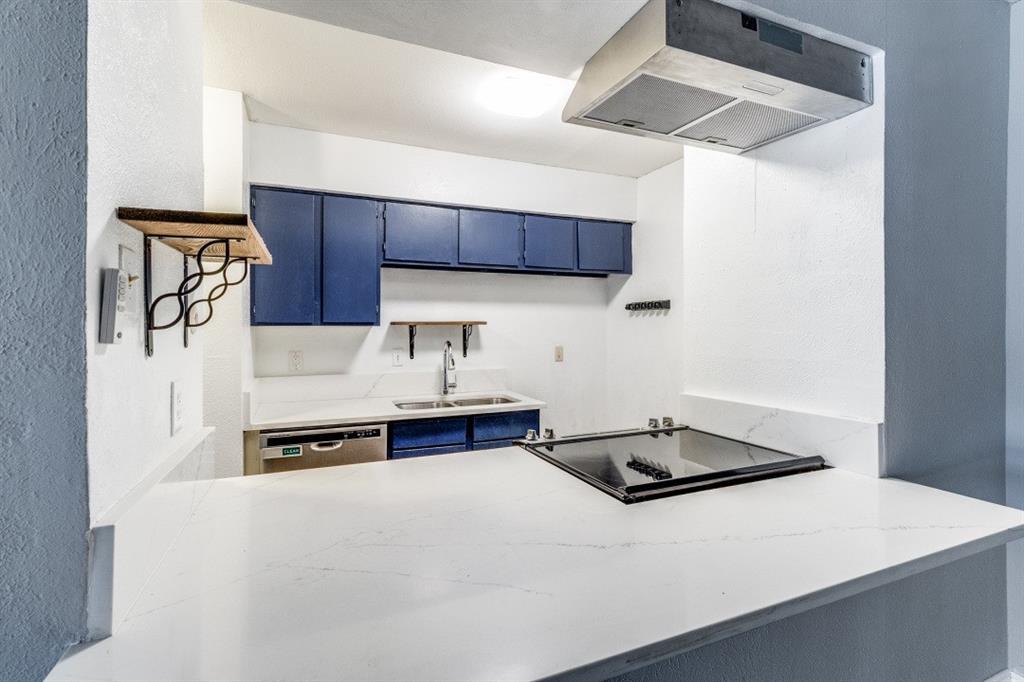 8110 Skillman Street, Unit 2019 Dallas, TX 75231 - Photo 8 of 13 a kitchen with stainless steel appliances a refrigerator a sink and a stove