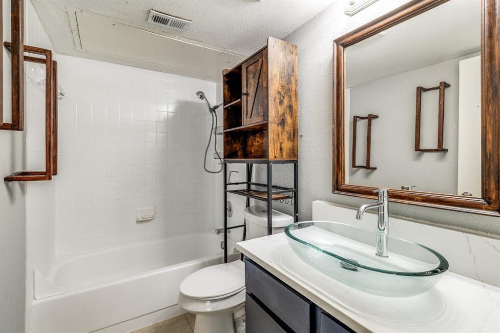 8110 Skillman Street, Unit 2019 Dallas, TX 75231 - Photo 10 of 13 a bathroom with a sink toilet and shower