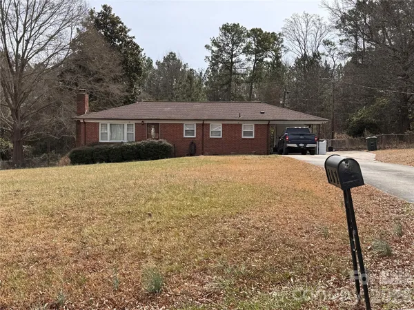 a front view of house with yard and trees