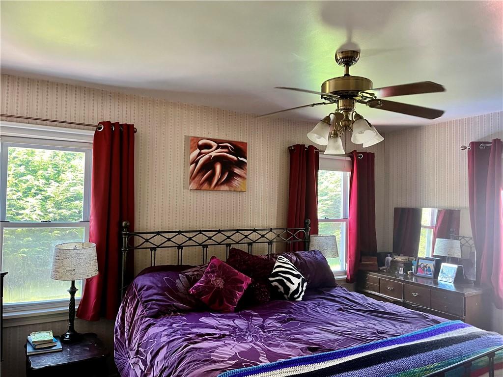 161 Freeport Road Butler, PA 16002 - Photo 12 of 24 a bedroom with a bed and a chandelier