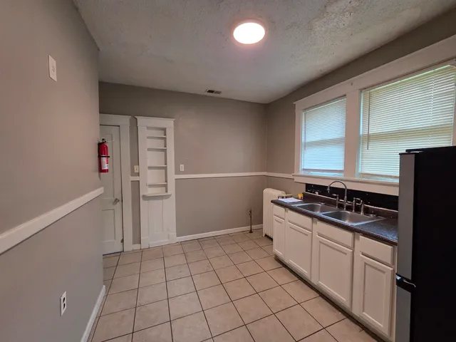 a kitchen with a stove and a refrigerator