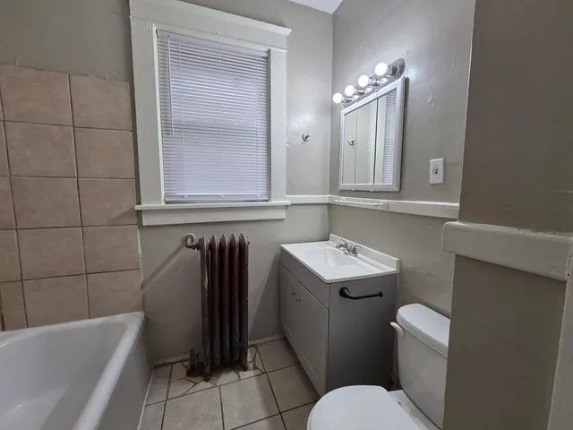a bathroom with a sink a toilet and bathtub