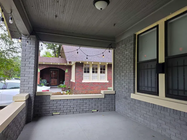 a front view of a house with outdoor seating
