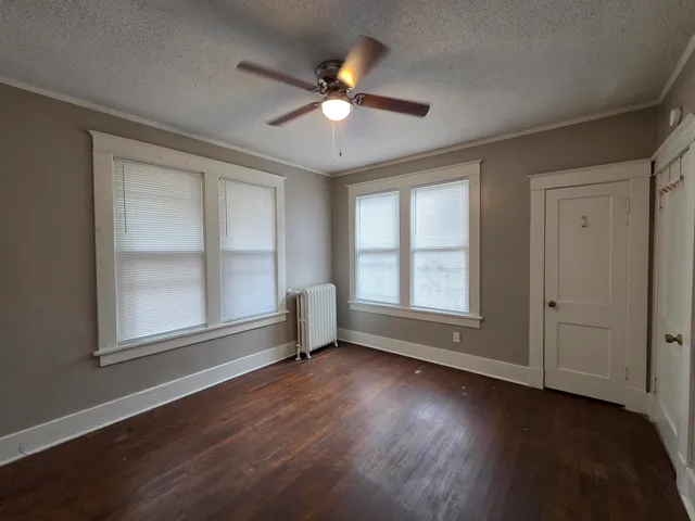 a view of wooden floor and a window in a room