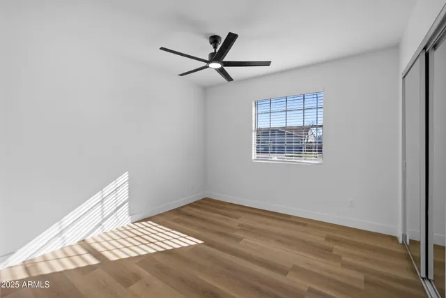 a view of room with wooden floor and window