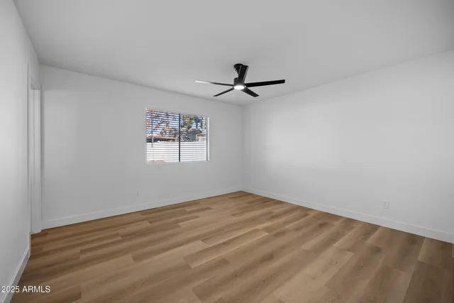a view of empty room with ceiling fan