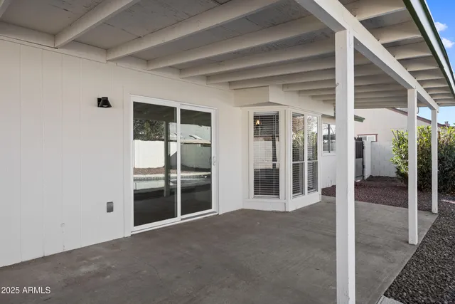 a view of a room with wooden floor and windows