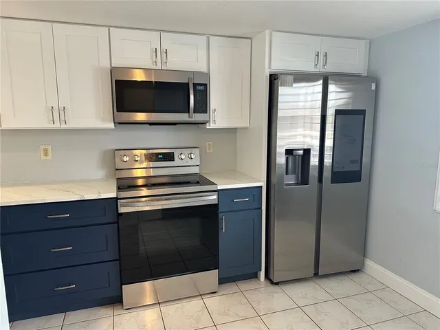 a kitchen with a refrigerator and microwave