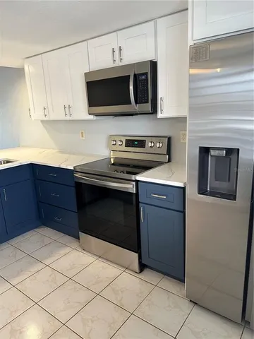 a kitchen with a cabinets and appliances