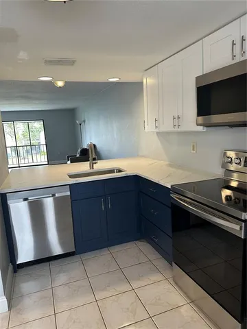 a kitchen with a sink and a stove top oven