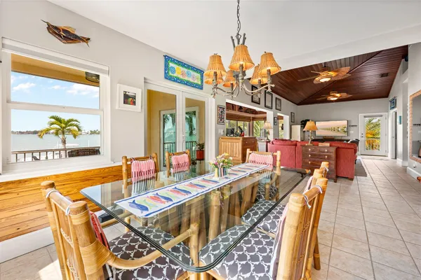 a dining room with furniture a chandelier and pool table