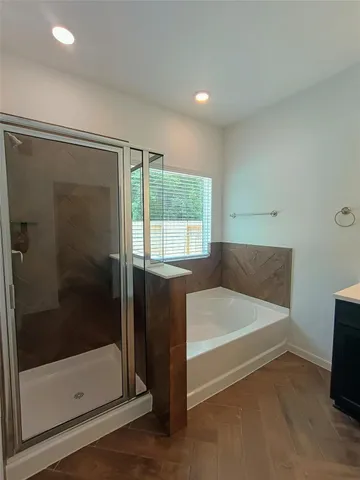 a bathroom with a bathtub and a shower