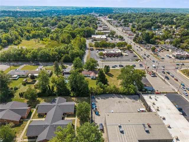 an aerial view of residential houses with outdoor space and river