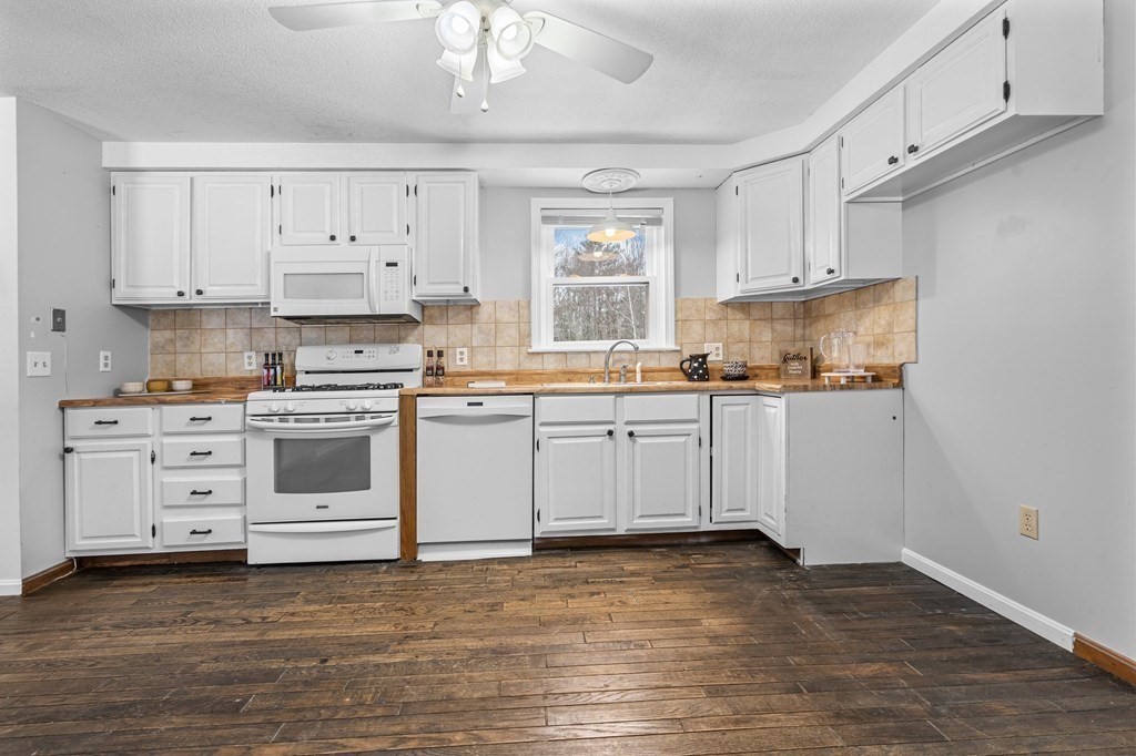 64 Gardner Road Winchendon, MA 01475 - Photo 8 of 40 a kitchen with white cabinets stainless steel appliances and sink