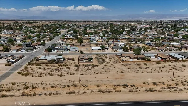 a view of a yard with wooden fence