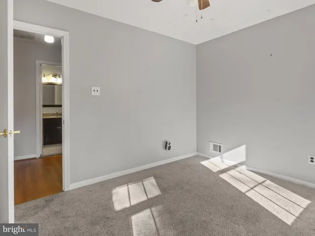 a bathroom with a sink a toilet a mirror and shower curtain