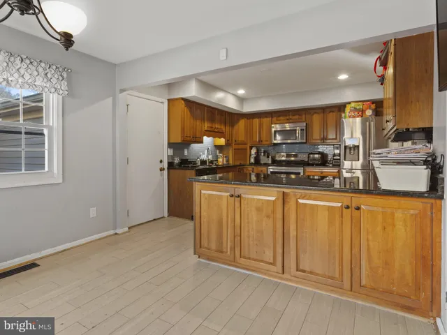 a kitchen with stainless steel appliances a refrigerator and cabinets