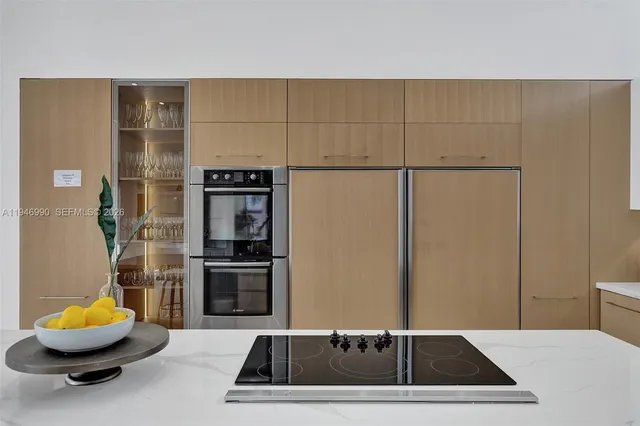 a bedroom with a bed next to a window with a flat screen tv