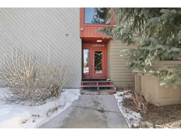 a kitchen with stainless steel appliances granite countertop white cabinets a stove a sink and dishwasher