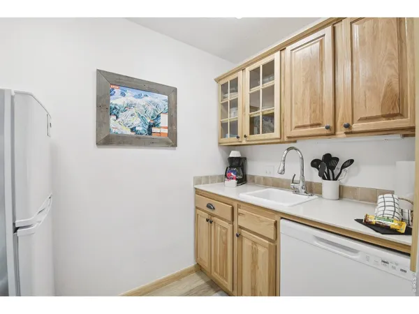 a kitchen with a sink cabinets and a window
