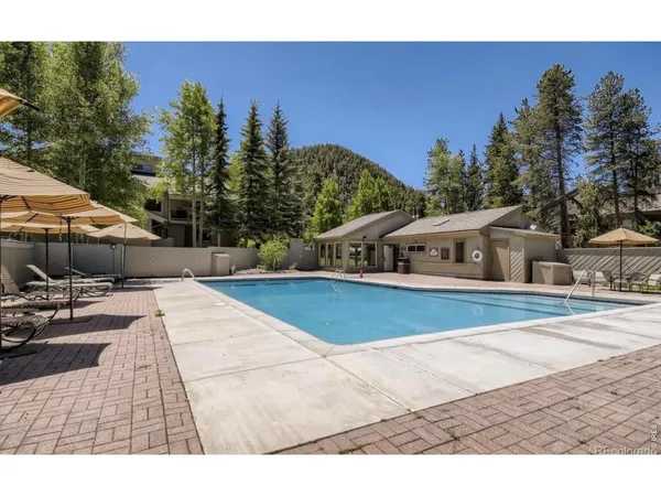 an aerial view of residential house with outdoor space and trees all around