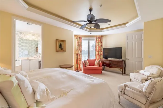 a bedroom with furniture and a flat screen tv