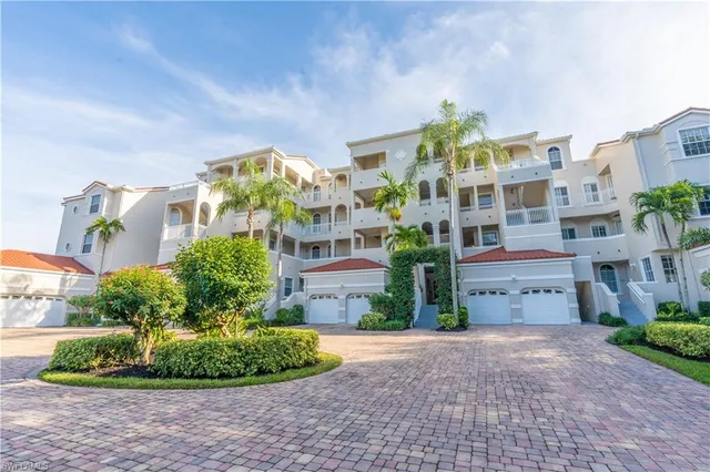an aerial view of residential houses with outdoor space and lake view