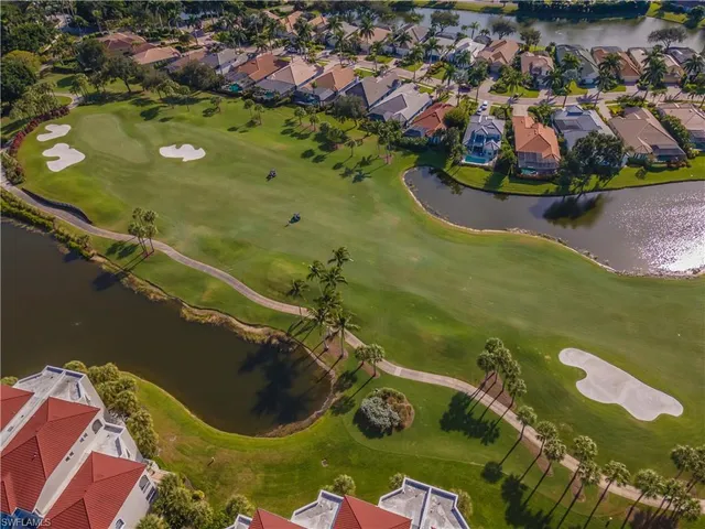 an aerial view of lake residential houses with outdoor space and swimming pool