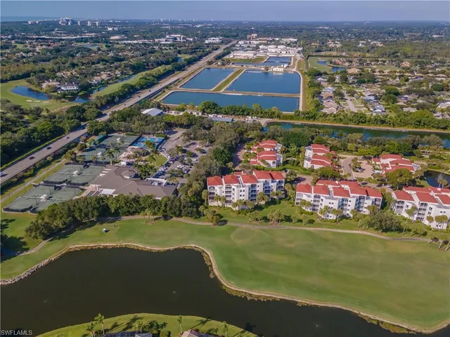 an aerial view of residential houses with outdoor space and river