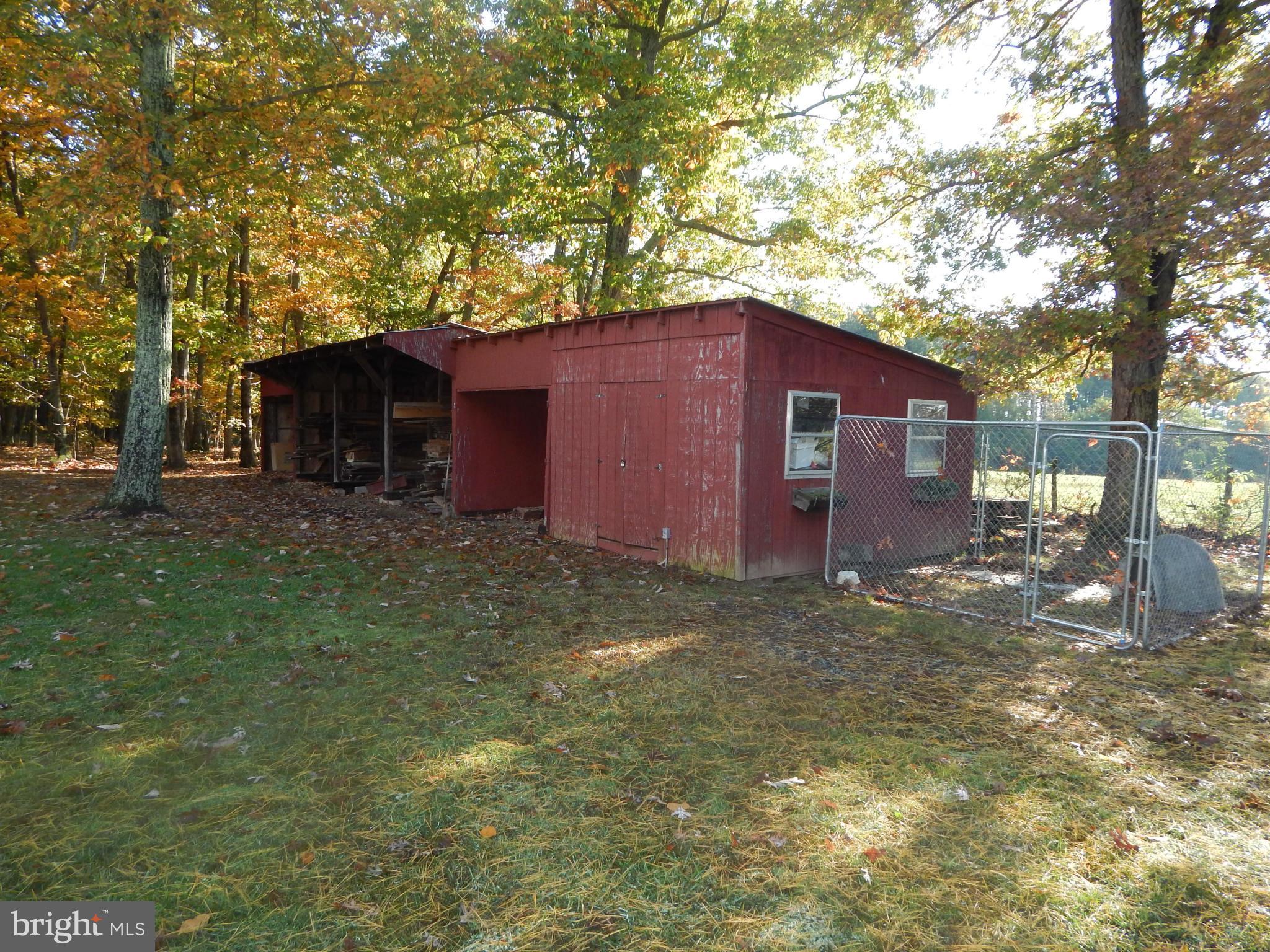 49 Duval Road Mineral, VA 23117 - Photo 19 of 22 a view of a backyard with large trees and a barn