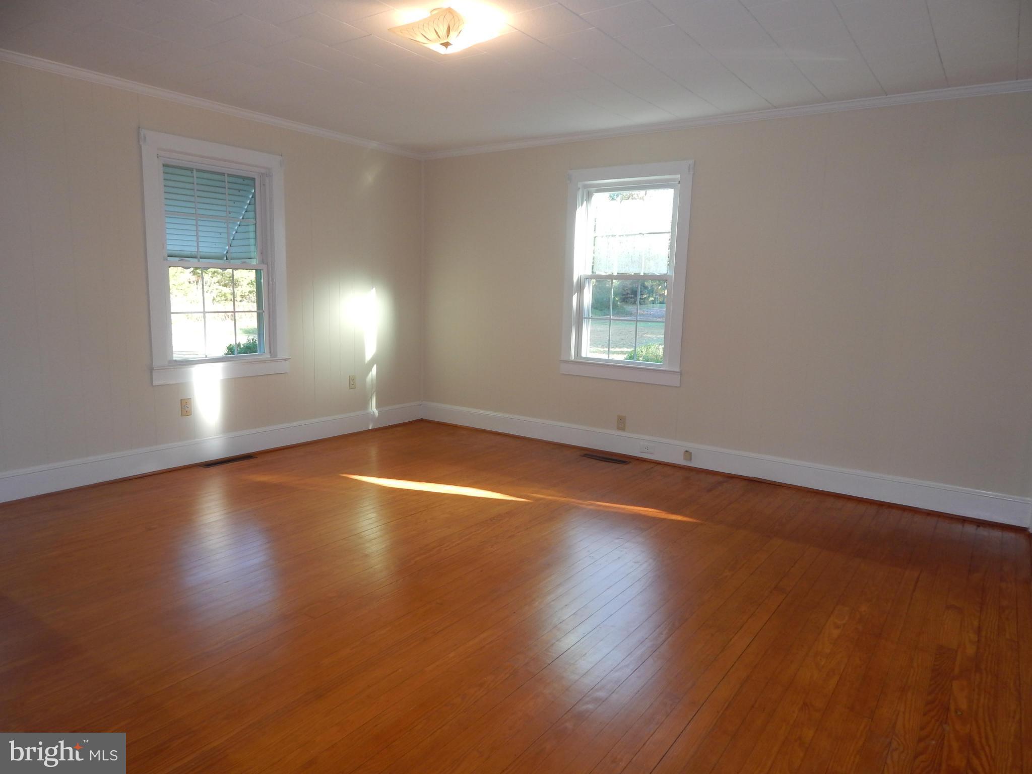 49 Duval Road Mineral, VA 23117 - Photo 8 of 22 an empty room with wooden floor and windows in it