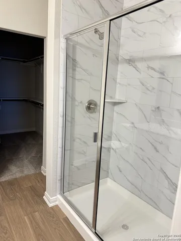 a bathroom with a glass shower door