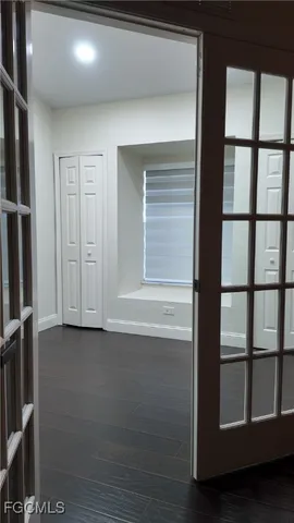 a view of empty room with wooden floor