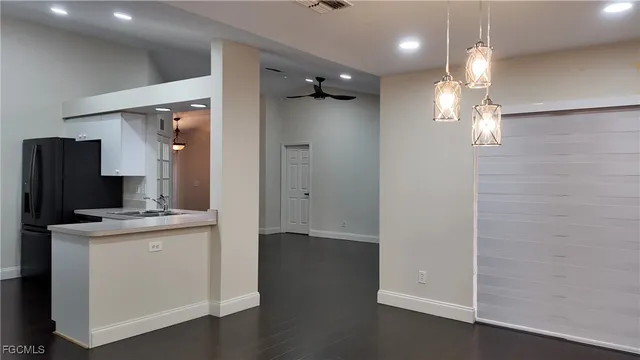 an empty room with kitchen and a sink