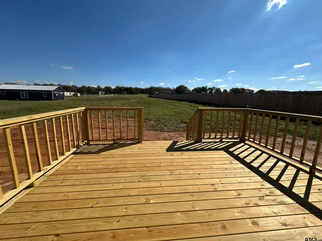 a view of balcony with wooden floor and city view