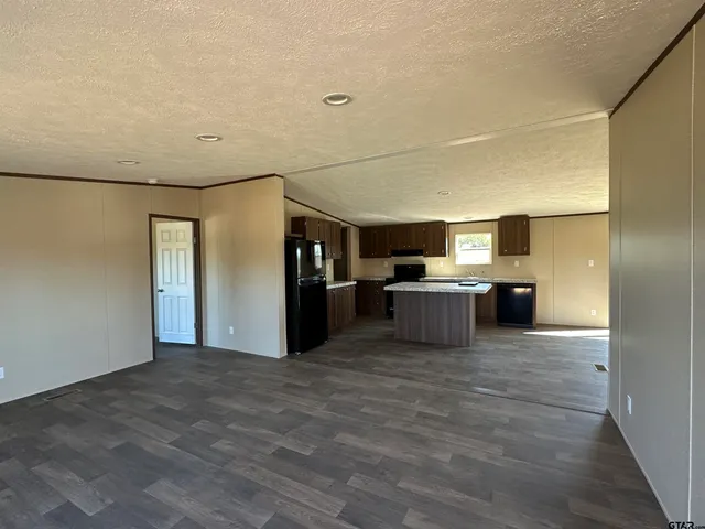 a view of a kitchen with a sink and a refrigerator