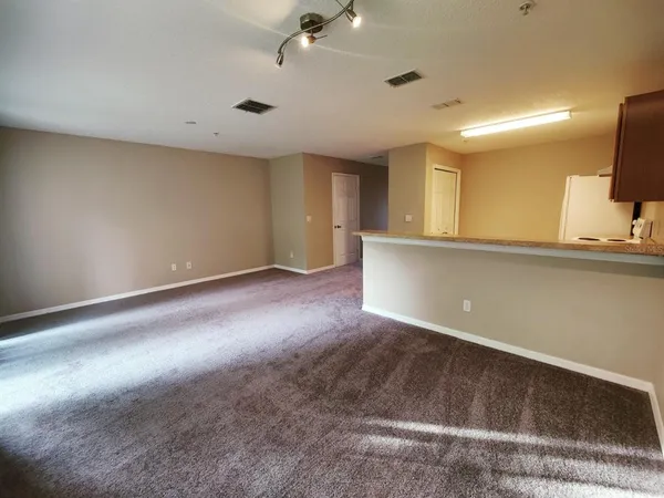 an empty room with a projector and screen