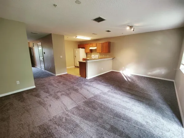 a view of a kitchen with a sink and cabinets
