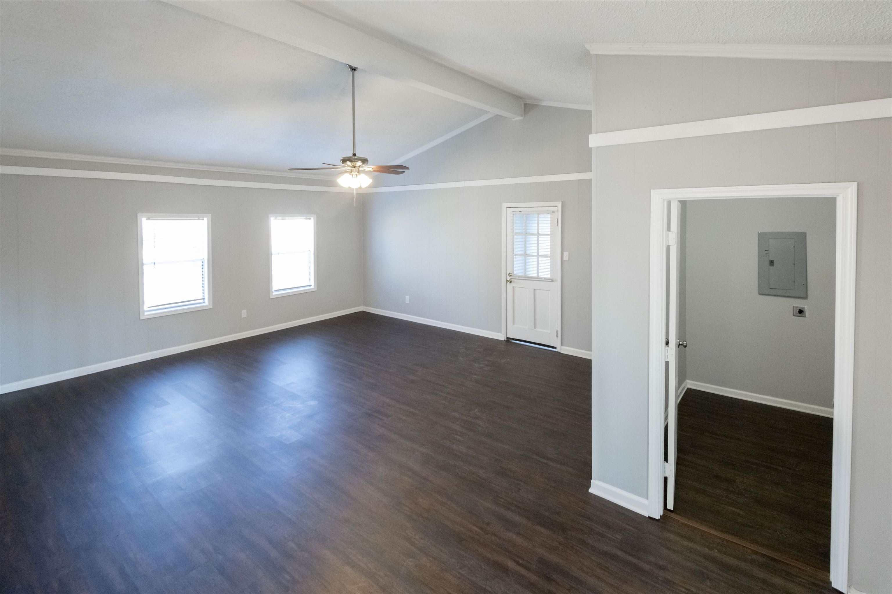 1547 Winfield Road Memphis, TN 38116 - Photo 3 of 20 an empty room with wooden floor cabinet and windows