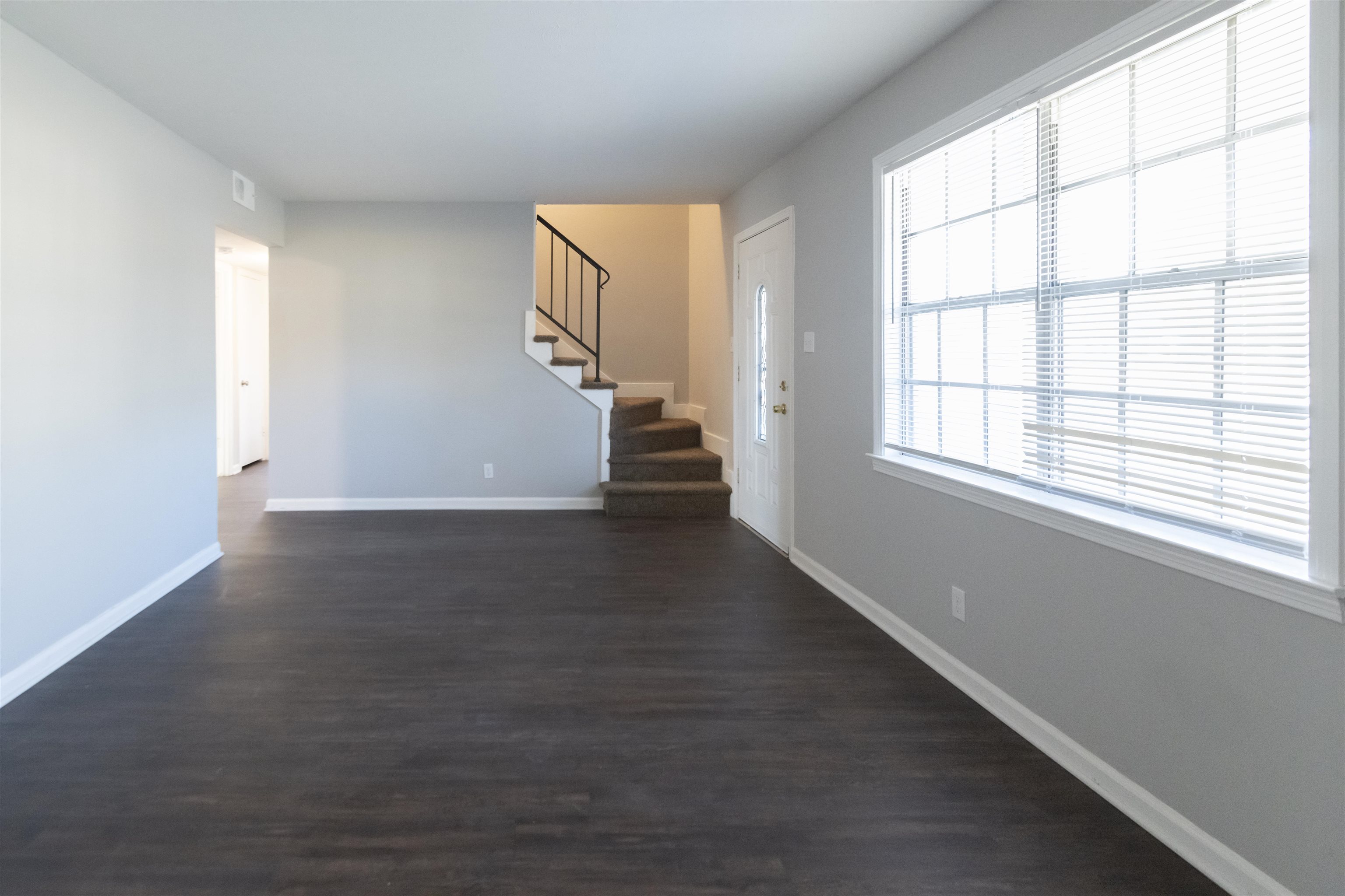 1547 Winfield Road Memphis, TN 38116 - Photo 4 of 20 an empty room with wooden floor and windows