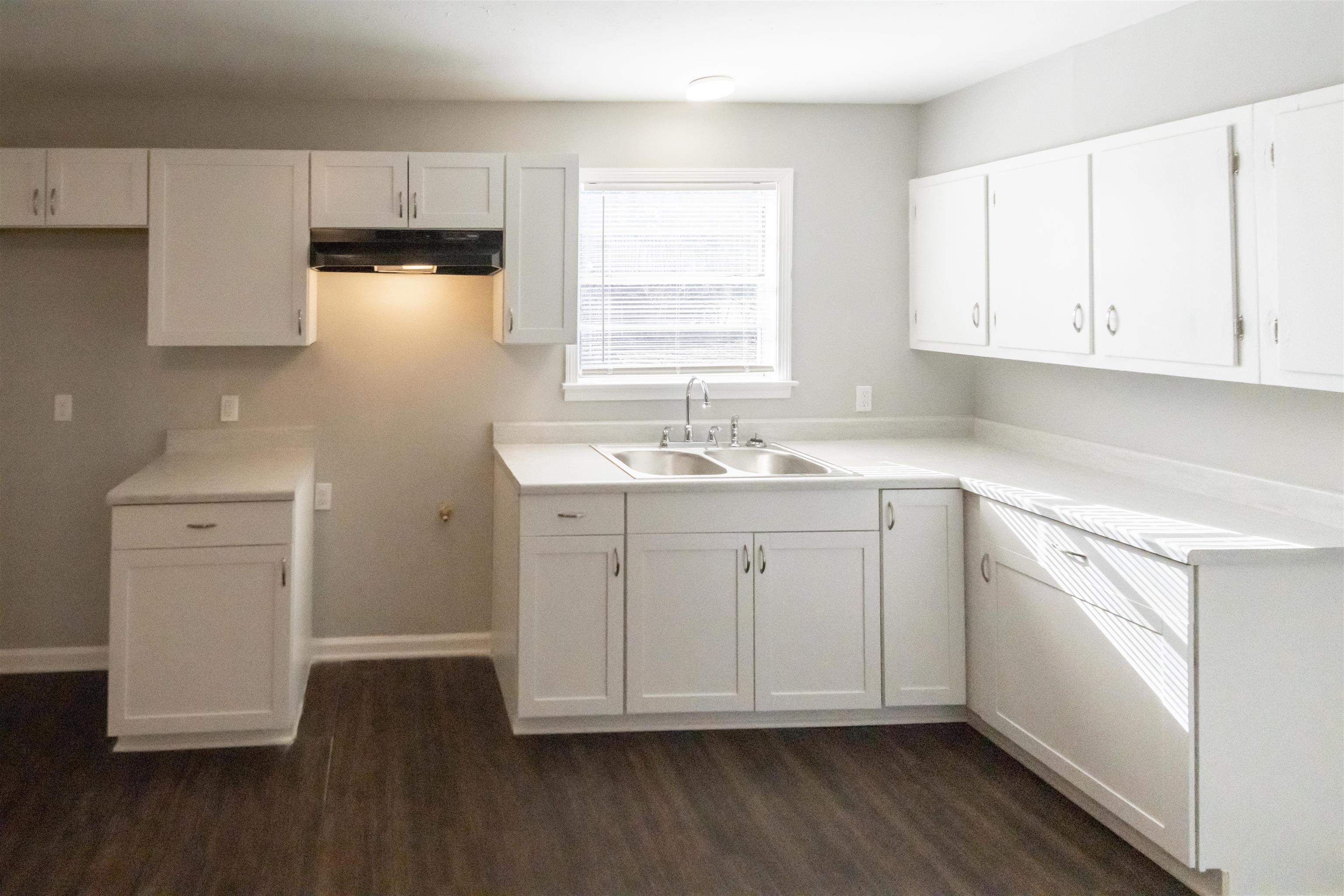 1547 Winfield Road Memphis, TN 38116 - Photo 6 of 20 a view of cabinets with wooden floor washer dryer and cabinets