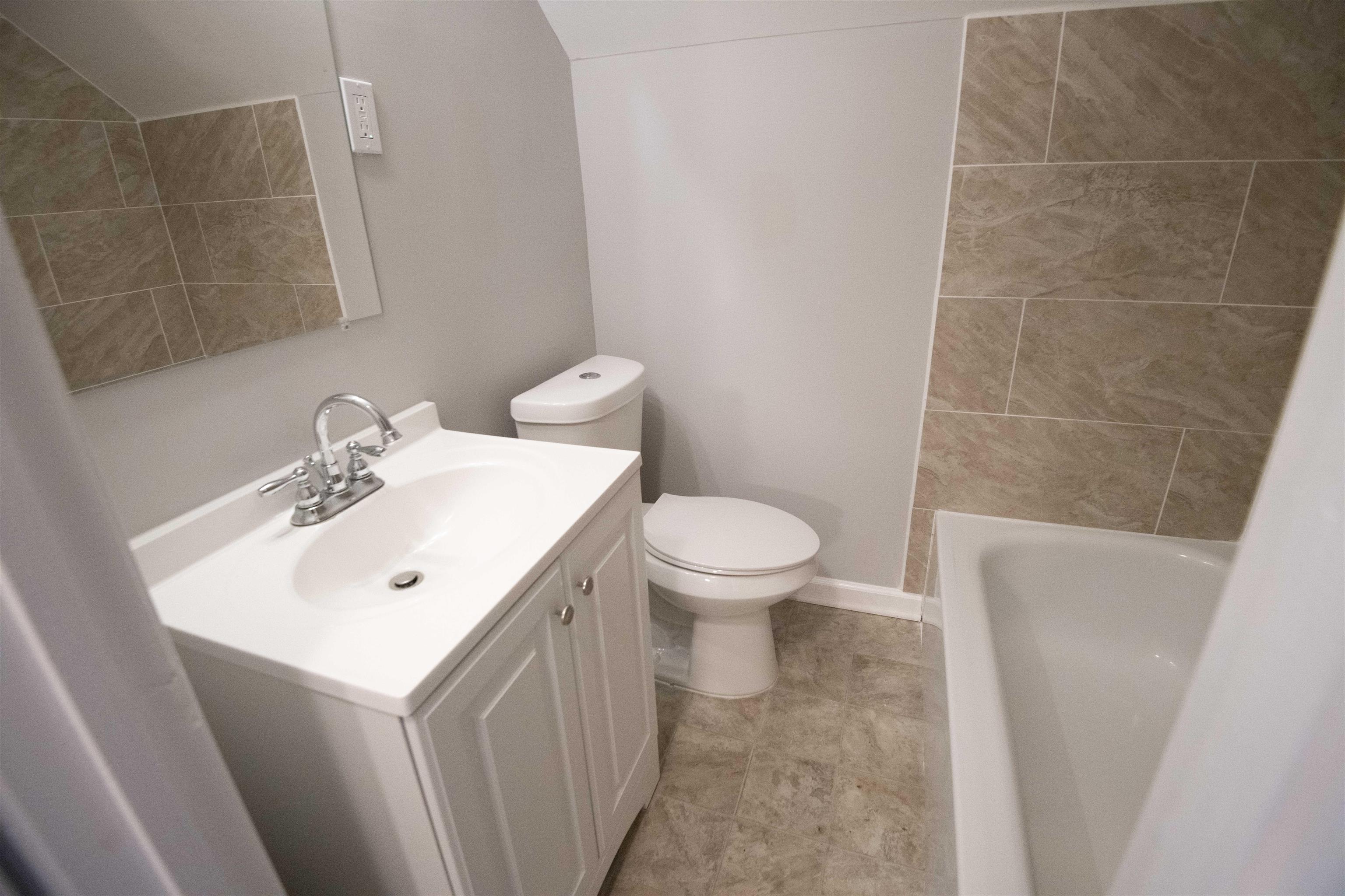 1547 Winfield Road Memphis, TN 38116 - Photo 8 of 20 a bathroom with a sink a toilet and shower