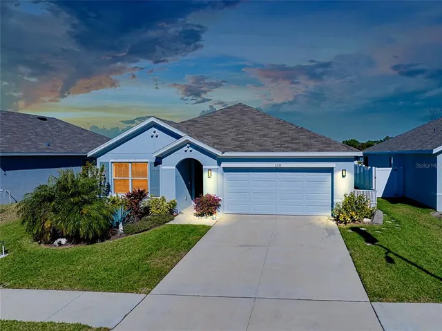 a front view of a house with a yard and garage