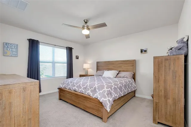 a bedroom with a bed and a chair