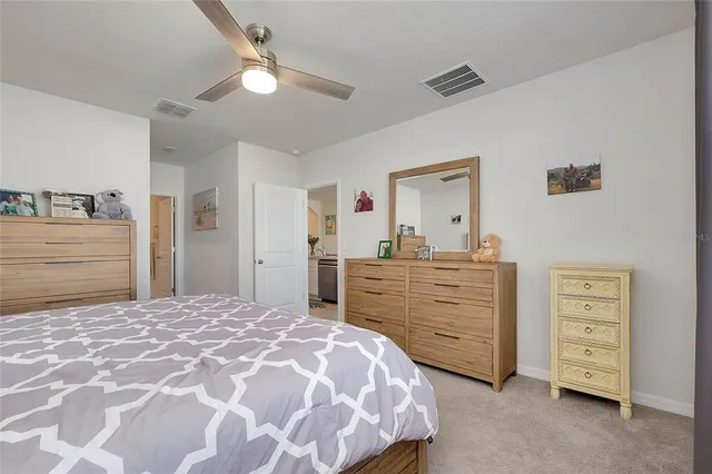 a bathroom with a granite countertop sink a toilet and a mirror
