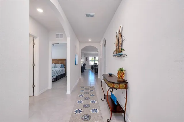 a living room with furniture and a dining table with kitchen view